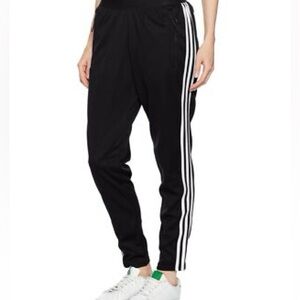 black Adidas track pants with white three-stripes and a slim fit 🍀